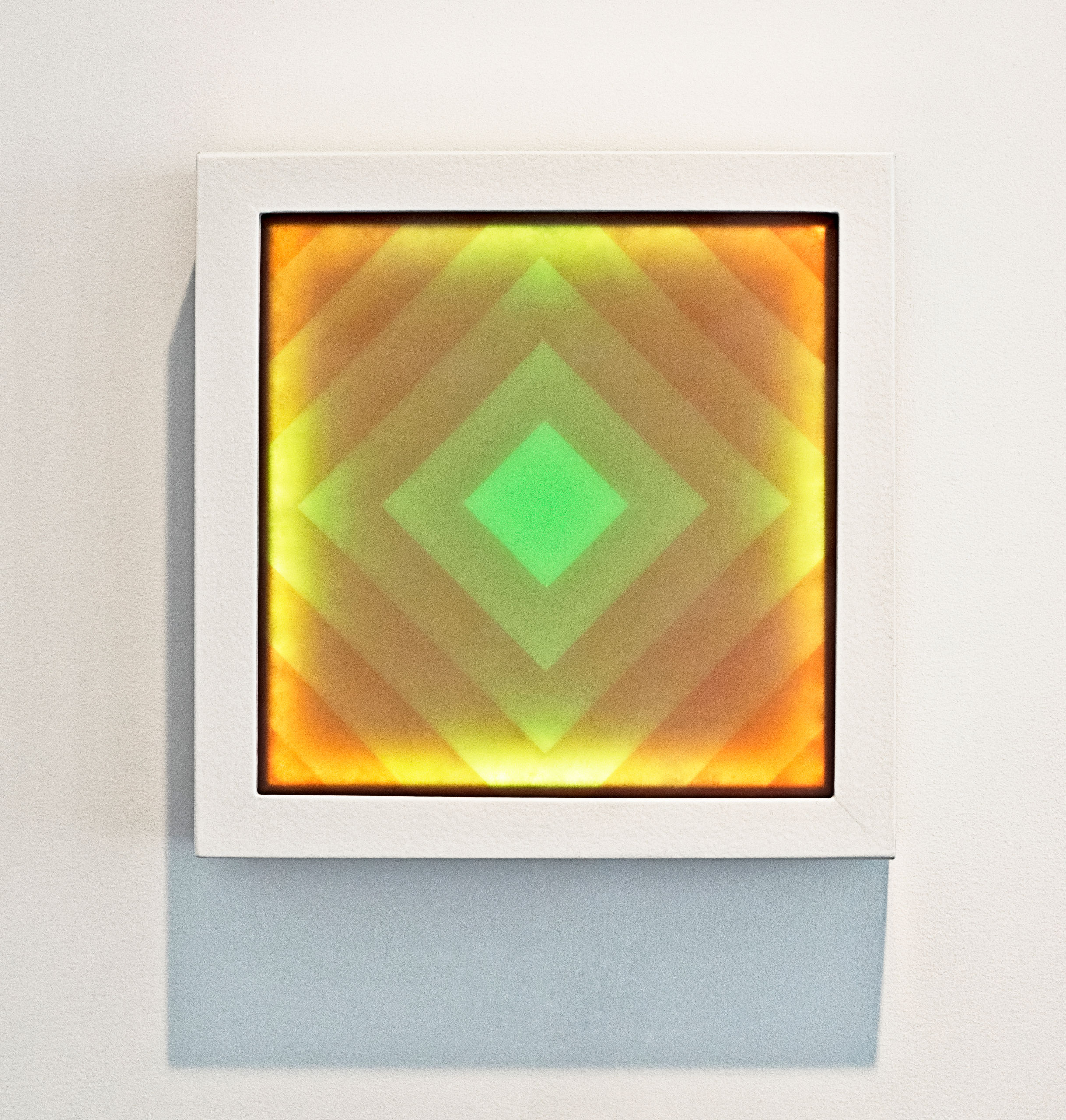 Orange and green light artwork with white frame.